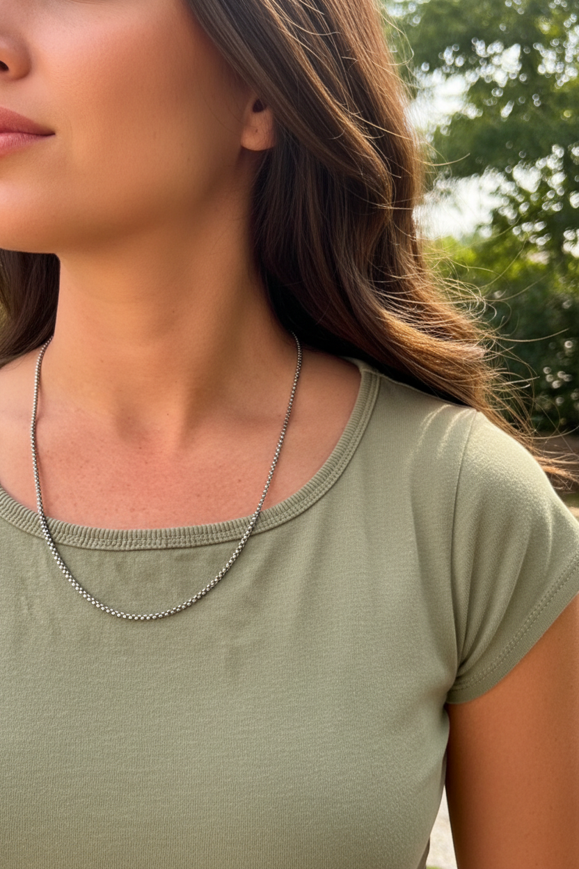 Silver box chain necklace on tanned woman